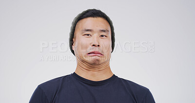 Buy stock photo Comic, funny face and portrait with man on studio space for emotions, humor or silly joke. Comedy, emoji and unique with goofy Asian person isolated on white background for crazy or quirky reaction