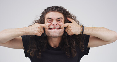 Buy stock photo Portrait, goofy and man with funny face, studio or silly with facial expression or white background. Comic, personality and person with playful gesture for comedy, reaction and comedian with joke