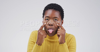 Buy stock photo Goofy, tongue out face and portrait of black woman in studio with open eyes, silly and comic facial expression. Crazy, joke and African female person with comedy gesture for humor by white background