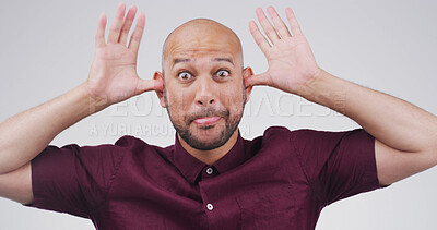 Buy stock photo Goofy, funny face and portrait of man in studio with crazy, silly and comic facial expression. Quirky, joke and male person from Brazil with comedy gesture for playful humor by white background.
