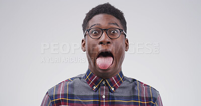 Buy stock photo Silly, black man and portrait with funny face or tongue out for joke on a white studio background. Male person, model or humor with glasses, comic or quirky personality for comedy on mockup space