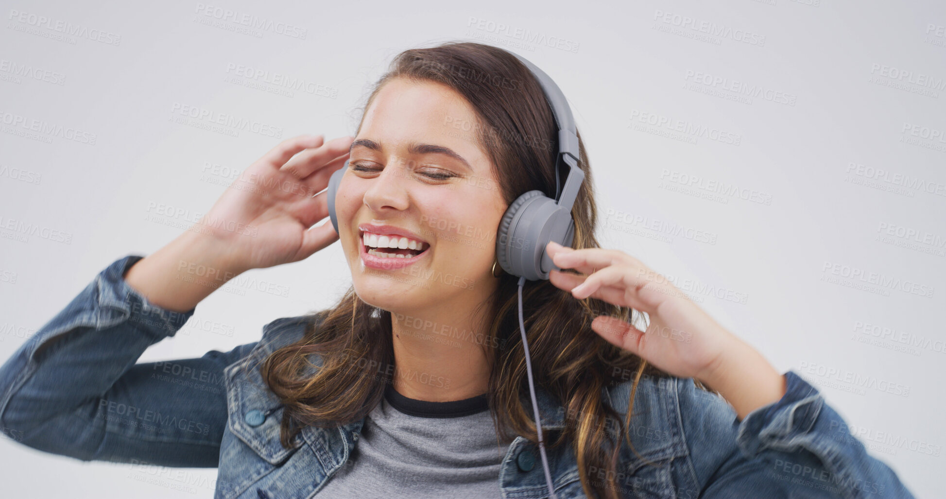 Buy stock photo Headphones, happy and woman in studio with music, playlist or radio online for dancing with smile. Streaming, gen z and person with audio tech for listening to song or album by white background.