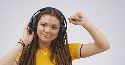 Buy stock photo Girl, portrait and dancing with headphones in studio for music playlist, streaming audio and rhythm. Happy, person and technology on white background for listening to sound track, energy and movement