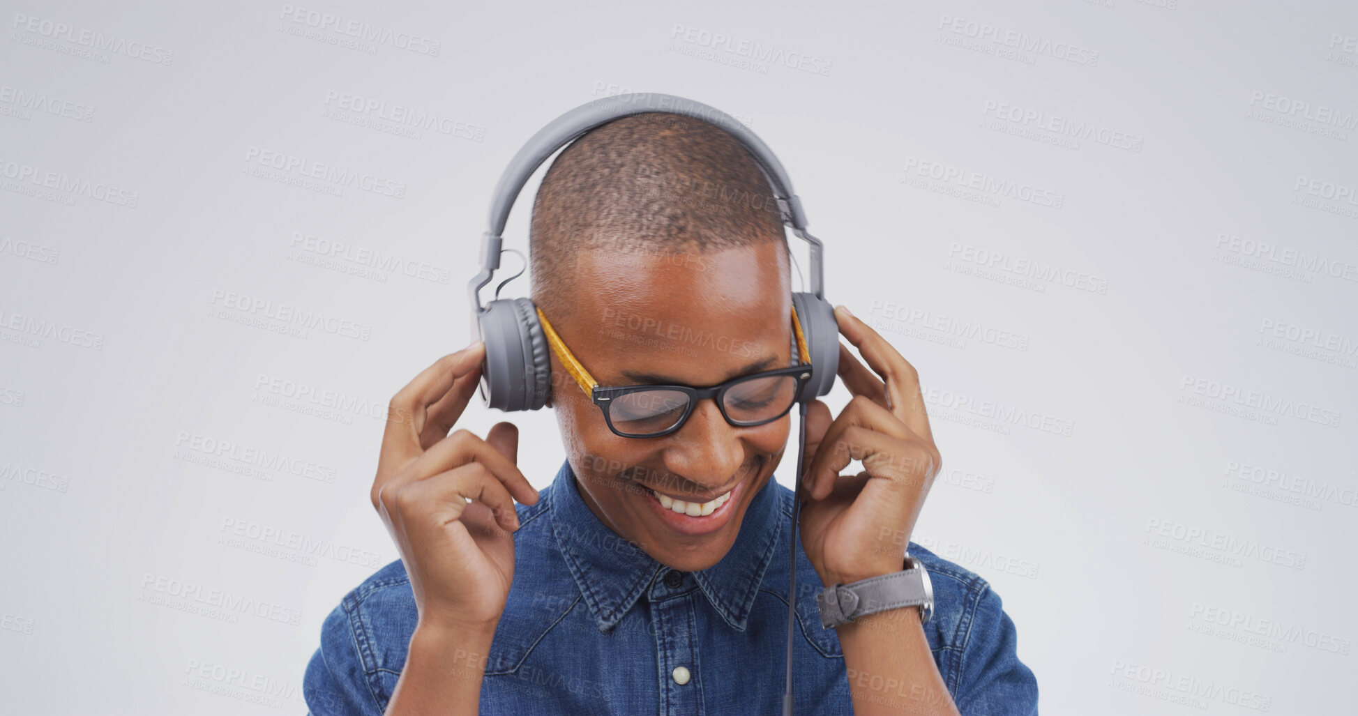 Buy stock photo Headphones, happy and black man in studio with music, playlist or radio online for dancing. Streaming, smile and African male person with audio tech for listening to song or album by white background
