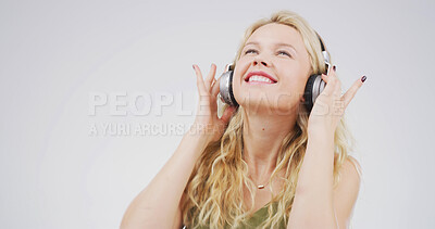 Buy stock photo Woman, headphones and smile in studio with sound, digital streaming and memory on white background. Person, happy and listen to music, radio and audio subscription with mock up space for song