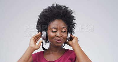 Buy stock photo Black woman, headphones and listen to music in studio with album, streaming or song on white background. African person, playlist and mockup space for audio subscription, radio and hearing hifi sound