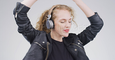 Buy stock photo Girl, music and dancing with headphones in studio for techno playlist, streaming audio and rhythm. Peaceful, person and technology on white background for listening to sound track, hands up and relax