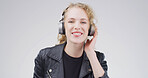 Girl, headphones and happy in studio portrait, digital streaming and album on white background. Woman, smile and listen to music playlist, radio and audio subscription with mock up space in Germany