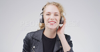 Buy stock photo Girl, headphones and happy in studio portrait, digital streaming and album on white background. Woman, smile and listen to music playlist, radio and audio subscription with mock up space in Germany