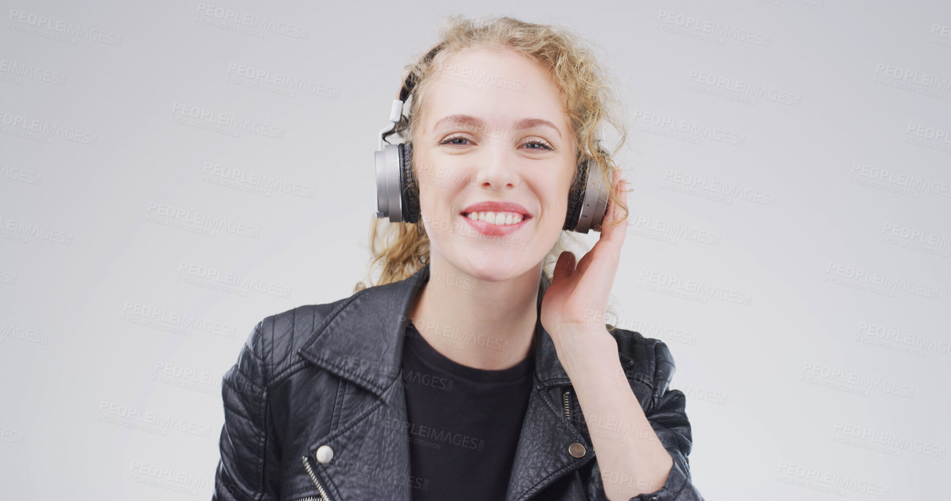 Buy stock photo Girl, headphones and happy in studio portrait, digital streaming and album on white background. Woman, smile and listen to music playlist, radio and audio subscription with mock up space in Germany