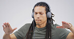 African man, dancing and headphones in studio with album, streaming or song on white background. Person, playlist and listen with mock up space for music subscription, radio and sound with rhythm