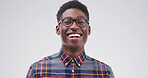 Portrait, black man and student laughing in studio for education, learning and space for university. Glasses, college geek and funny African person with scholarship on white background in Tanzania