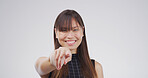 Portrait, pointing to you and woman in studio, selection and confidence on white background. Face, hand gesture and person with happiness, decision and encouragement with choice, emoji or opportunity