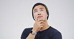 Thinking, choice and man in studio with uncertain for decision, brainstorming or question. Ideas, mockup space and Asian male person with problem solving, planning or doubt by white background.