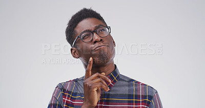 Buy stock photo African man, thinking and student in studio with mock up space, confused or doubt on white background. Person, nerd and perspective for education, solution or choice with mindset for problem solving