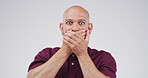 Portrait, man and shocked expression in studio for gossip reaction, bad news and fake rumor. Male person, space and cover mouth for horror story, scary drama and secret revelation on white background