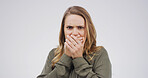 Scared, shocked and portrait of woman in studio with omg, wtf or wow reaction for news. Emotion, surprise and female person with hands covering mouth for rumor or announcement by white background.