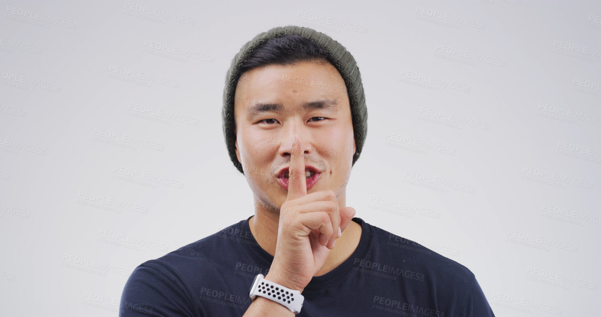 Buy stock photo Happy, portrait and man in studio with secret, gossip or confidential hand gesture for privacy. Quiet, smile and Asian male person with finger on lips for silence or noise control by white background