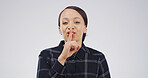 Happy, portrait and woman in studio with quiet, gossip or confidential hand gesture for privacy. Secret, smile and Asian person with finger on lips for silence or noise control by white background.