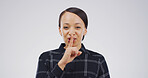 Portrait, finger on lips and woman with privacy sign, gossip and emoji on white studio background. Noise control, gesture and person with mystery news, confidential and whisper with body language