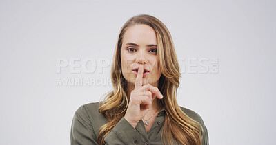 Buy stock photo Portrait, finger on lips and woman in studio, secret and privacy sign on white background. Face, hand gesture and person with mystery news, silence and whisper with gossip, confidential and emoji