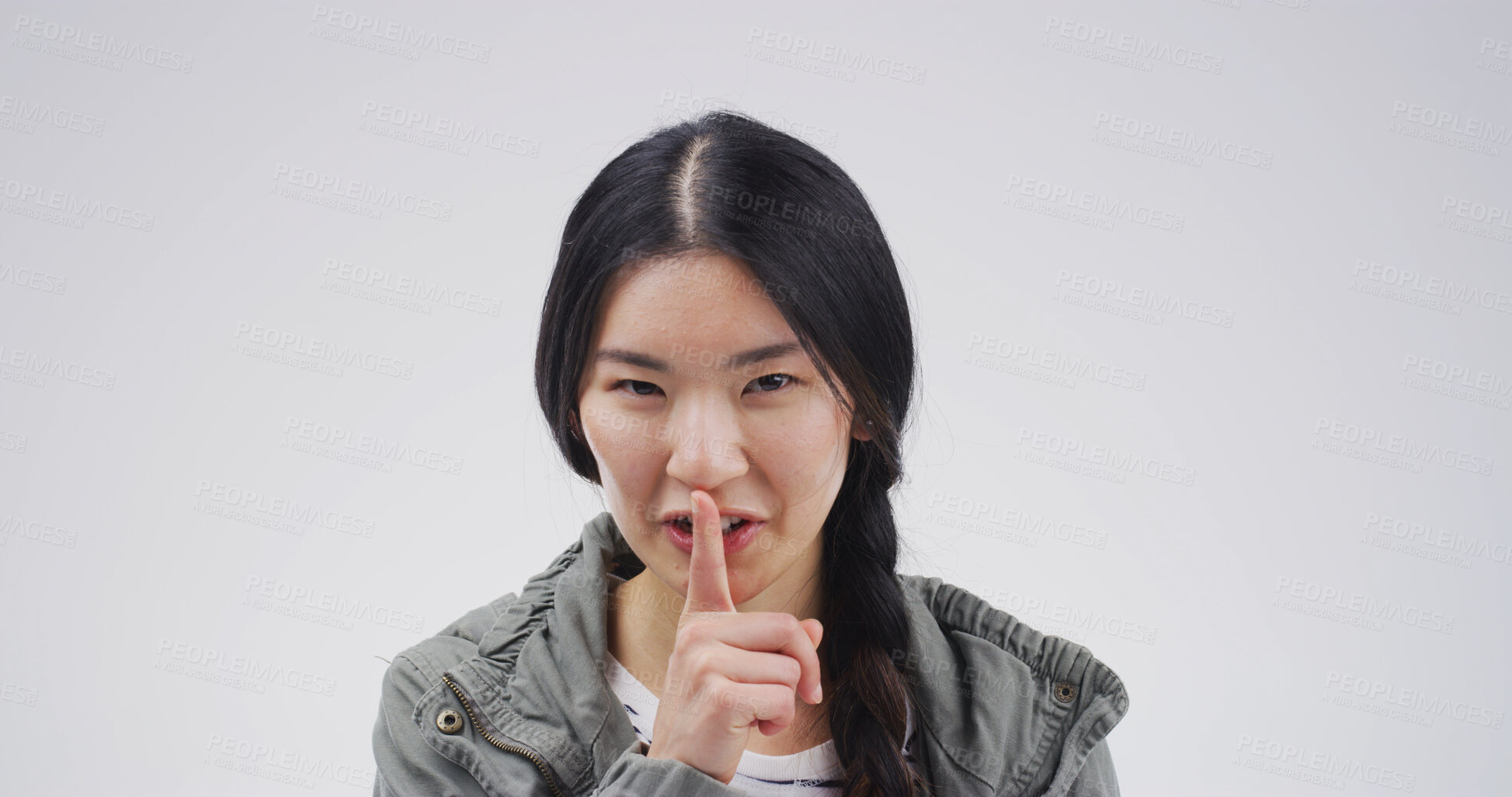 Buy stock photo Hush, portrait and secret with woman on studio space for gossip, silence or whisper. Emoji, finger on lips and privacy with Asian person isolated on white background for confidential information