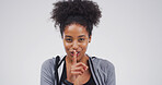 Black woman, portrait and finger with hush, studio and silence for mystery announcement. Model, gossip and secret with rumor, whisper and gesture for news, opinion and privacy on white background