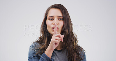Buy stock photo Portrait, sneaky and woman with gesture for secret, white background or silence with sign for shush. Studio, quiet and person with finger for privacy, shut up and mysterious with confidential news