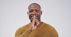 Black man, portrait and finger with hush, studio and silence for mystery announcement. Model, gossip and secret with rumor, whisper and gesture for news, opinion and privacy on white background
