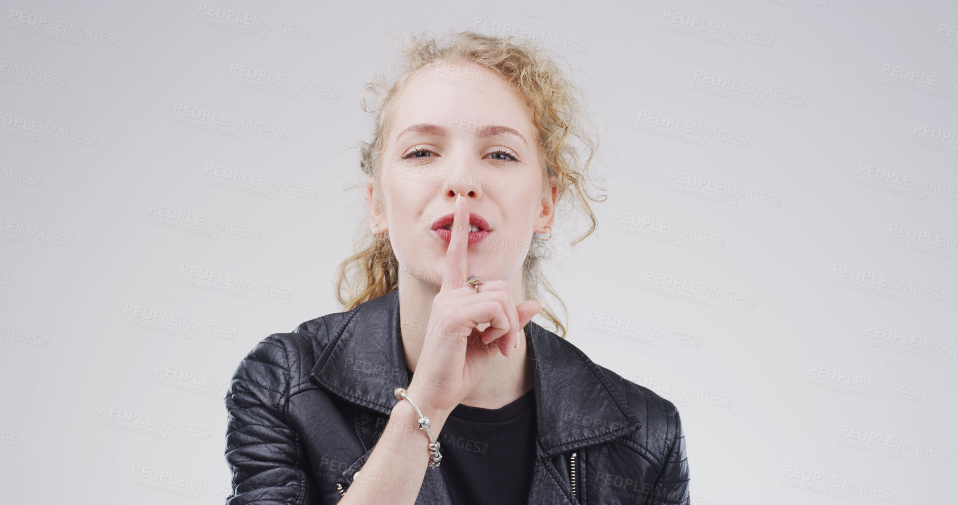 Buy stock photo Portrait, finger on lips and woman with whisper, shush and privacy sign on white studio background. Face, gesture and person with mystery news, silence and emoji with gossip, confidential and secret