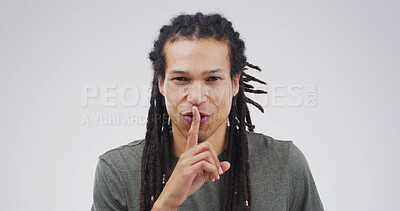 Buy stock photo Happy, portrait and man in studio with silence, gossip or confidential hand gesture for privacy. Quiet, smile and male person with finger on lips for secret or noise control by white background.