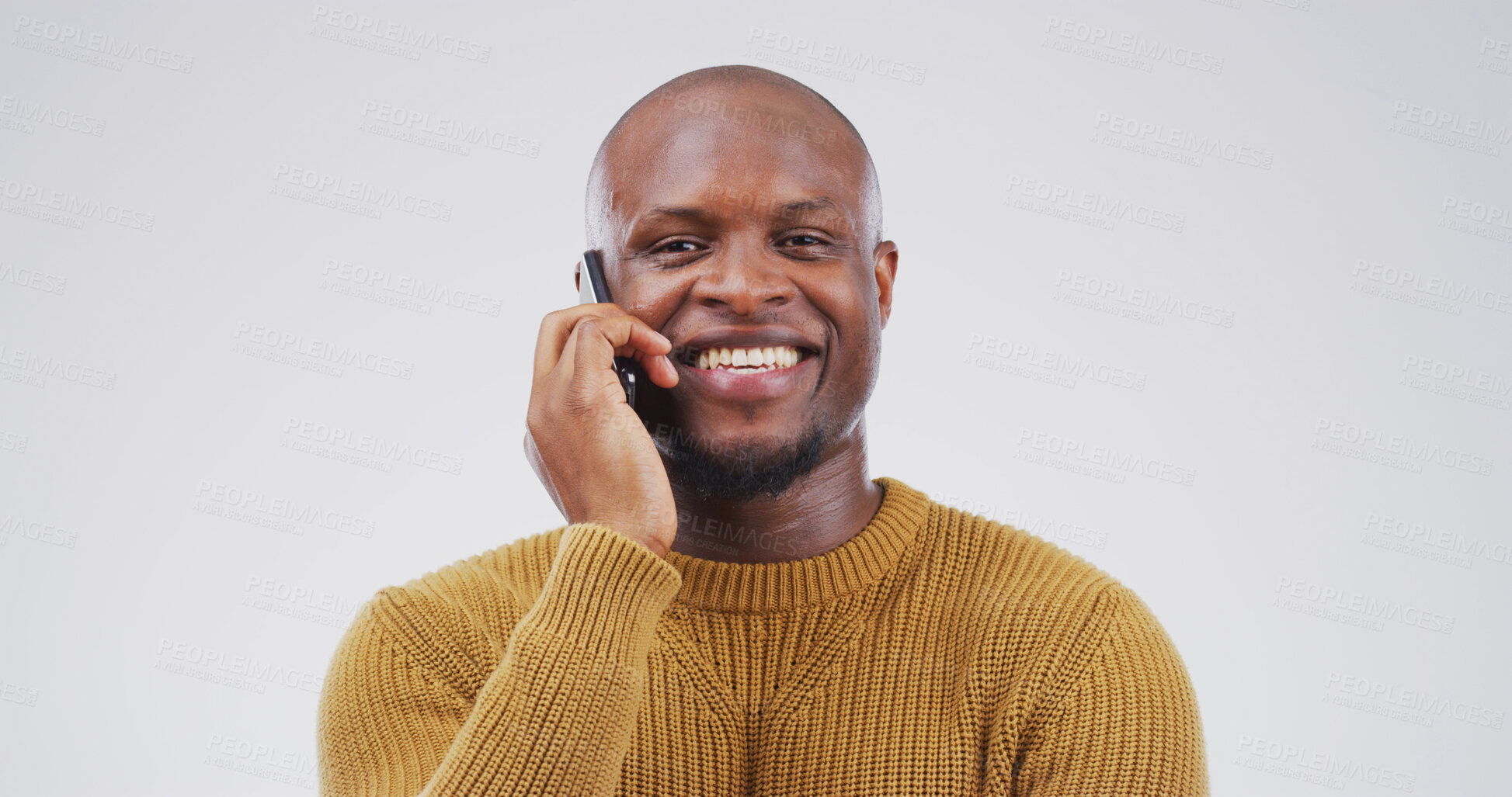 Buy stock photo Portrait, phone call and happy black man in studio for communication, connection or story. Mobile, smile and African person listening to contact for news, feedback and chat on white background space