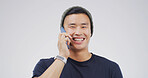 Asian man, phone call and happy in studio portrait with contact, chat or discussion on white background. Person, college student and smartphone with smile, mobile network and mockup space in Cambodia