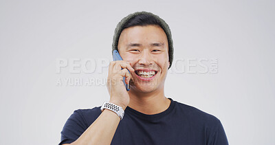 Buy stock photo Asian man, phone call and happy in studio portrait with contact, chat or discussion on white background. Person, college student and smartphone with smile, mobile network and mockup space in Cambodia