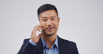 Buy stock photo Businessman, phone call and smile in studio for talk, mock up space and contact on white background. Asian person, corporate lawyer and happy for legal consultation, advice and deal in Indonesia