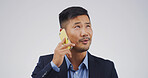 Businessman, phone call and thinking in studio for talk, mock up space and contact on white background. Asian person, corporate lawyer and listen with legal consultation, advice or mobile networking