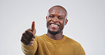 Black man, portrait and smile with thumbs up in studio, motivation or promotion with praise. Agreement, success or hand gesture for yes, thank you or feedback with sign for review on white background