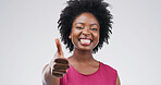 Portrait, smile and black woman with thumbs up in studio for success, support or agreement. Happy, model and like hand gesture with emoji for feedback, excellence and review on white background space