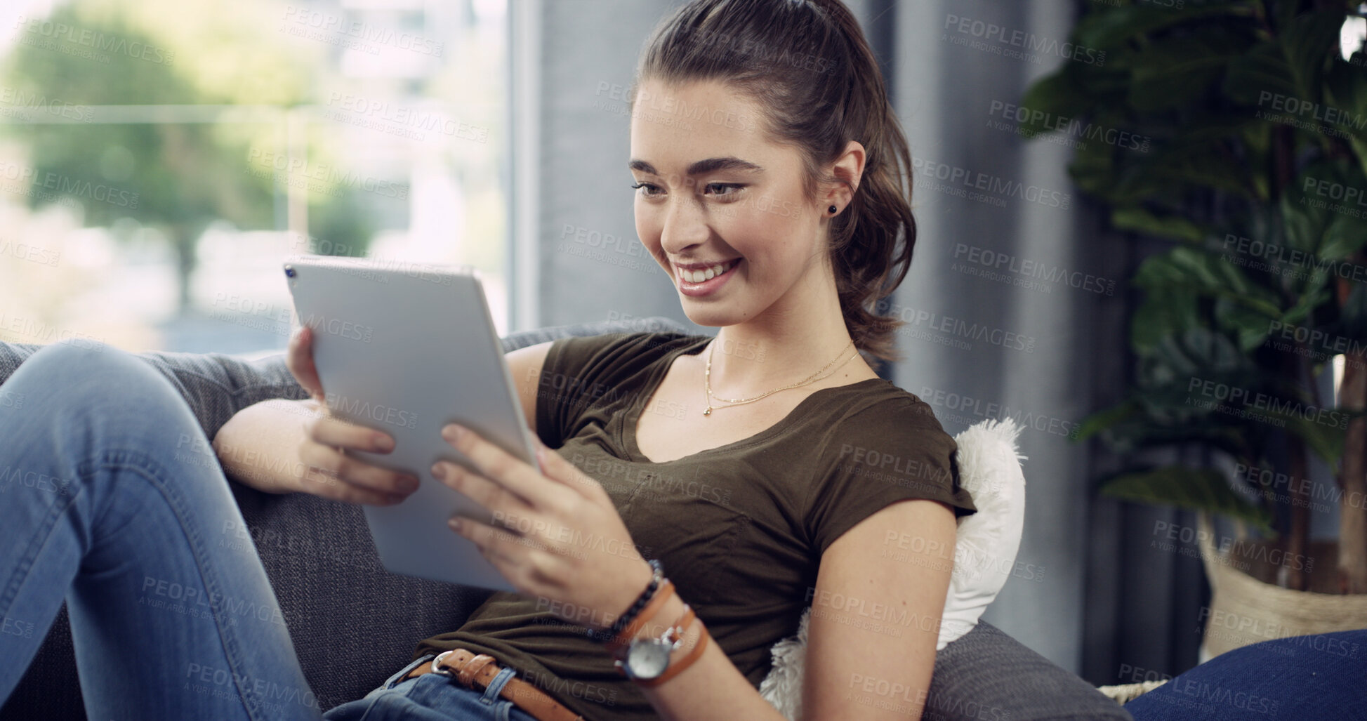 Buy stock photo Tablet, happy and woman on sofa in home reading ebook, blog or research on app for weekend activity. Relax, calm and female person with digital technology for social media in living room at apartment