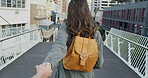 Holding hands, adventure and woman in city on holiday, travel or weekend trip for sightseeing. Love, POV and back of female person with boyfriend on vacation together in urban town for getaway.
