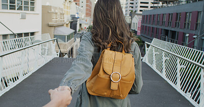 Buy stock photo Holding hands, adventure and woman in city on holiday, travel or weekend trip for sightseeing. Love, POV and back of female person with boyfriend on vacation together in urban town for getaway.