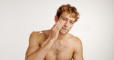 Buy stock photo Beauty, facial and portrait with man in studio for grooming, hygiene or wellness routine. Cosmetics, lotion and skincare with person on white background to apply face cream or moisturizer in bathroom