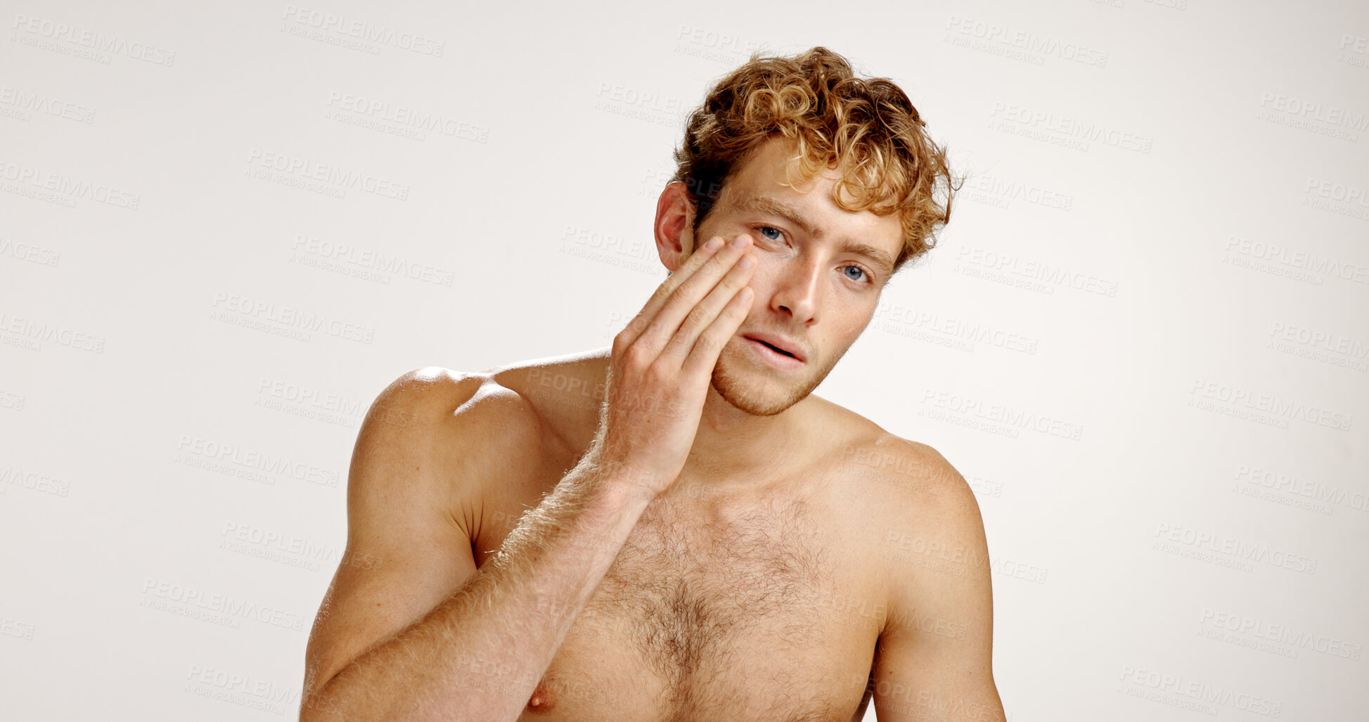 Buy stock photo Beauty, facial and portrait with man in studio for grooming, hygiene or wellness routine. Cosmetics, lotion and skincare with person on white background to apply face cream or moisturizer in bathroom