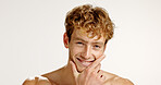 Beauty, man and smile for skincare, studio or dermatology for smooth skin, portrait or mockup space. White background, confident and facial treatment for person, shirtless and happy for glow in USA