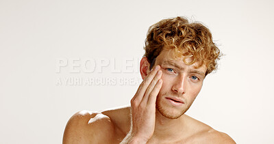 Buy stock photo Beauty, portrait and skincare with man in studio for grooming, hygiene or wellness routine. Cosmetics, facial and lotion with person on white background to apply face cream or moisturizer in bathroom