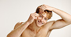 Portrait, smile and man with tweezers in studio for hair removal, beauty and skincare routine. Happy, male person and tools to pluck eyebrows, facial grooming and transformation on white background