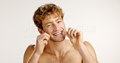 Buy stock photo Oral care, floss and portrait of man in studio with hygiene, wellness and mouth routine. Dental health, fresh breath and person with string for cleaning teeth with plaque removal by white background.