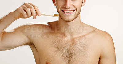 Buy stock photo Dental care, smile and man brushing teeth in studio for fresh breath, wellness or plaque removal. Morning, oral health and person with toothbrush for cleaning mouth with hygiene by white background.