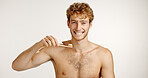 Dental care, portrait and man brushing teeth in studio for fresh breath, wellness or plaque removal. Morning, health and person with toothbrush for cleaning mouth with hygiene by white background.