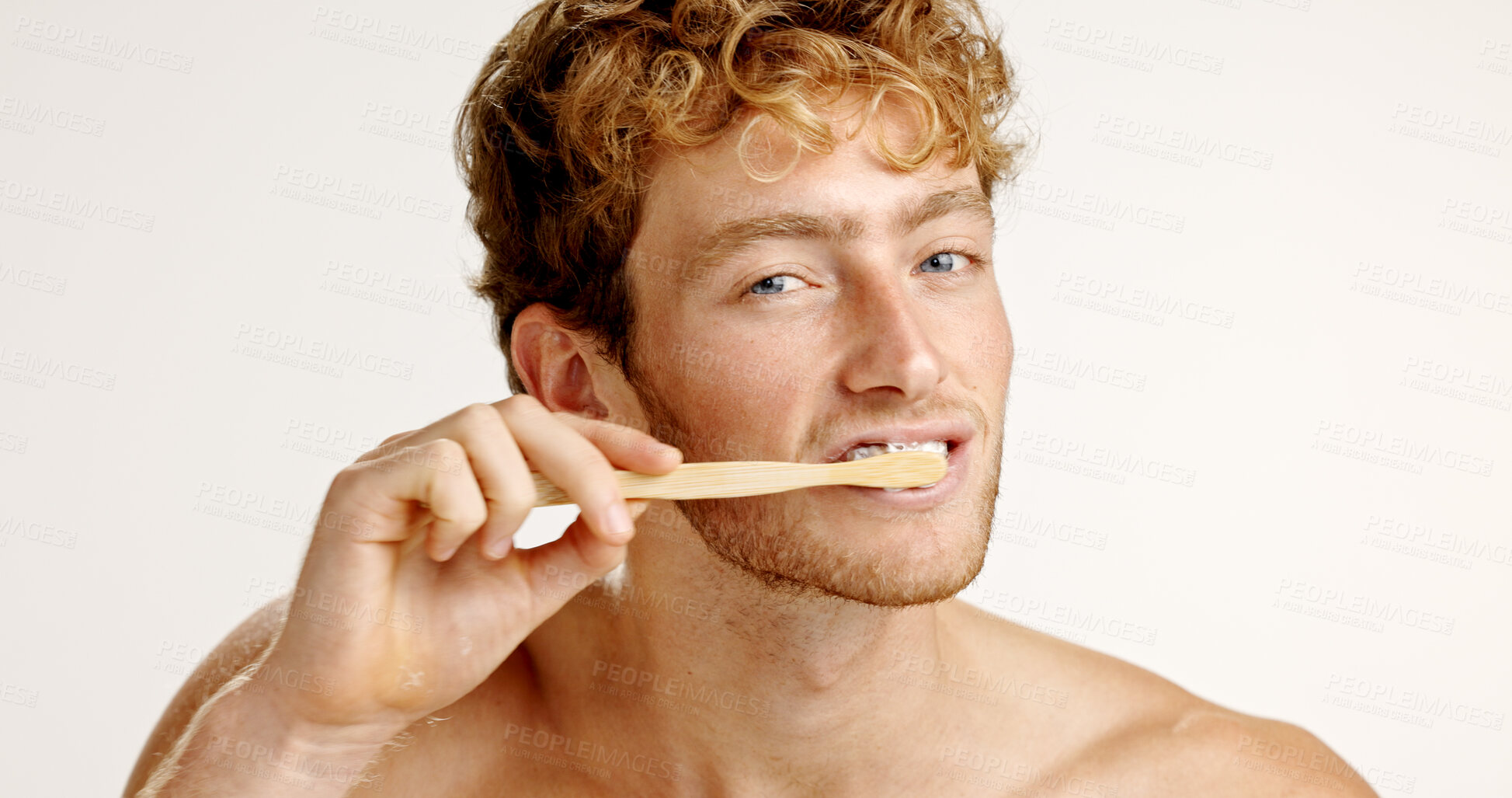 Buy stock photo Oral care, portrait and man brushing teeth in studio for fresh breath, wellness or plaque removal. Morning, dental hygiene and male person with toothbrush for cleaning mouth by white background.